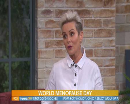 relaxed corporate team, tranquil expression, meditating in a circle, photorealistic, rooftop garden with skyscrapers around, highly detailed, gentle breeze moving plants, high resolution, earthy tones, natural daylight, shot with a 50mm lens.